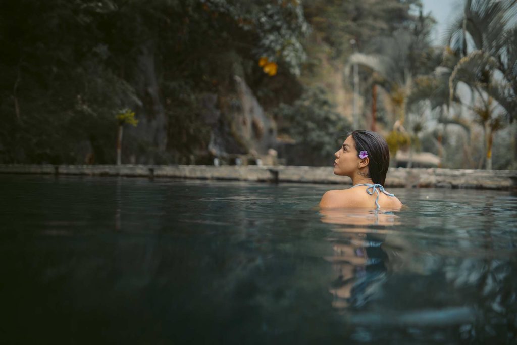 Trekker relaxing in the Cocalmayo Hot Springs on the Inca Jungle Trek.