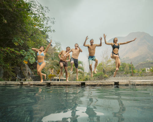 Group of tourists at the Cocalmayo hot springs on the Inca Jungle route