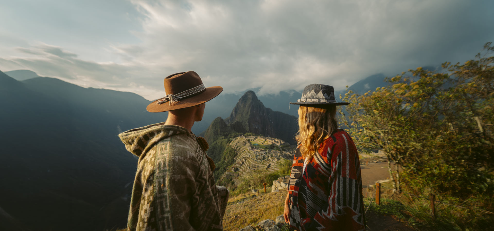 A couple of tourists at the Inca citadel of Machu Picchu
